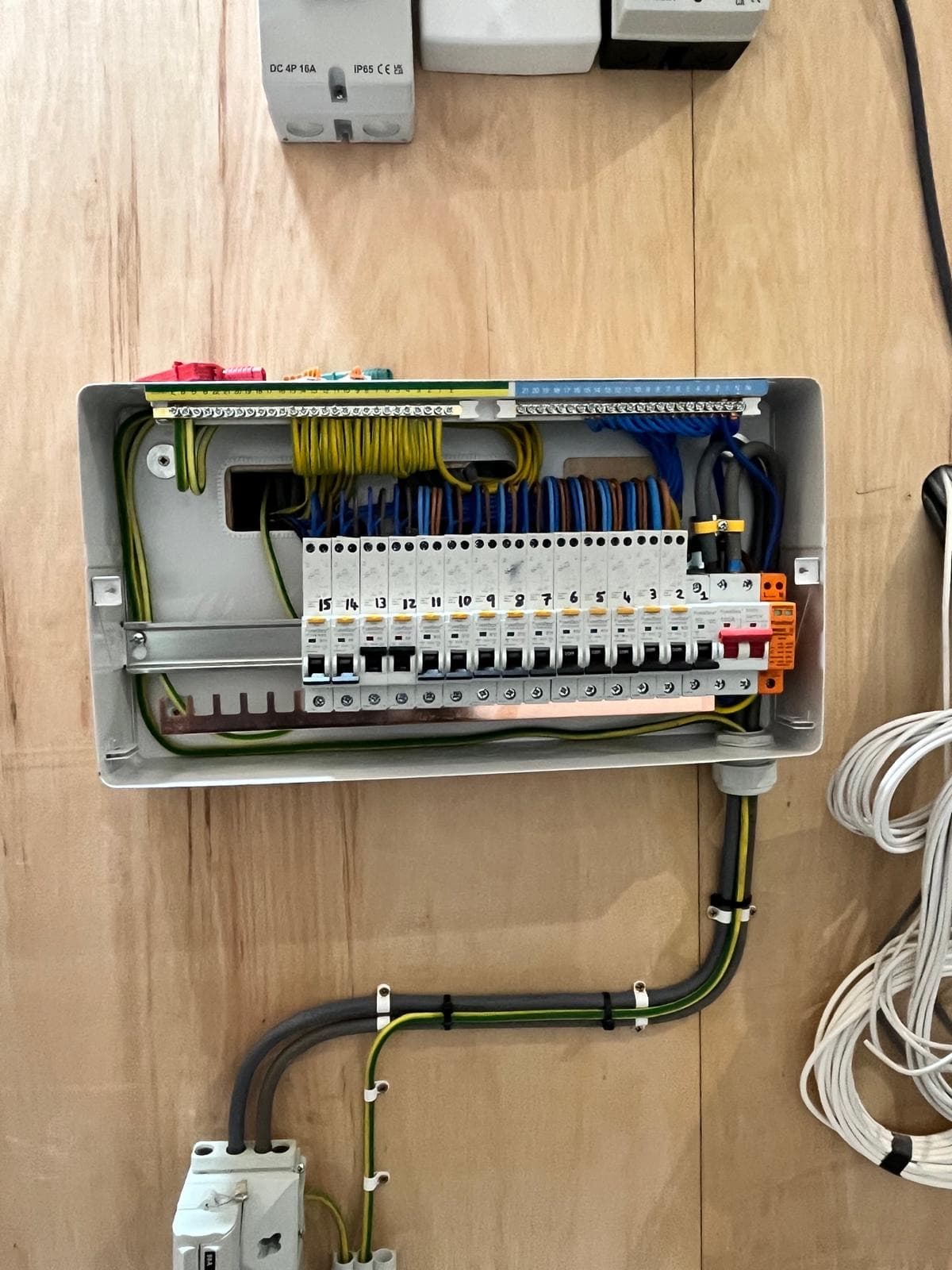 New consumer unit with the cover off, showing neatly dressed wiring, numbered breakers and surge protection, installed by Gunning Electrical Services